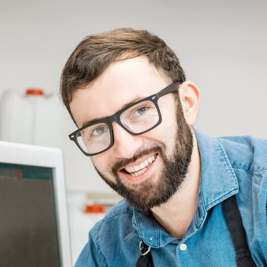 Man working with spectrometer at the manufacturing